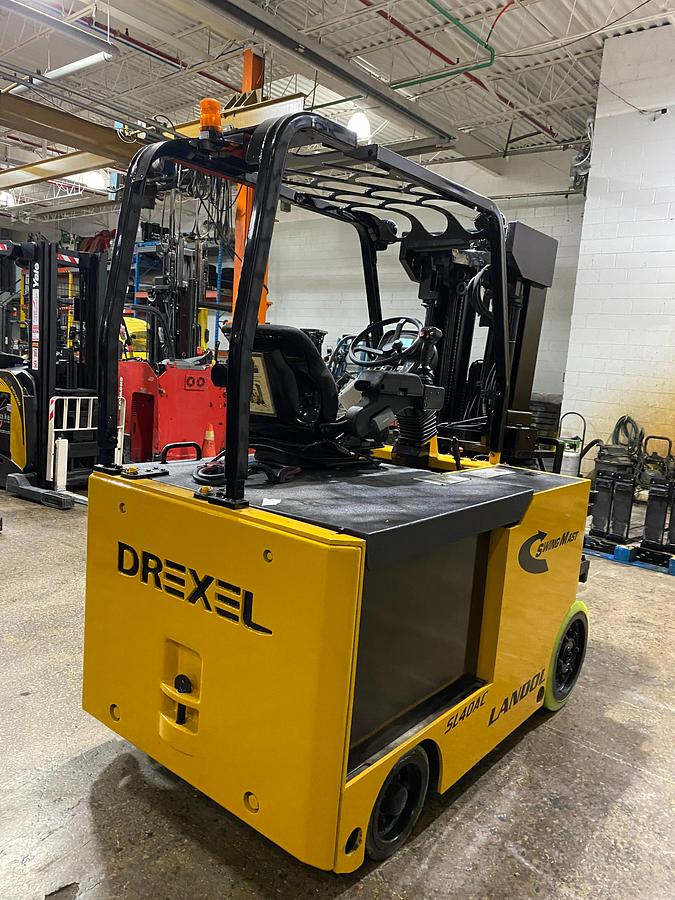 Rear side angle of Drexel SL-40AC SwingMast forklift showing counterweight, rear wheels, and CSA certification during warehouse deployment