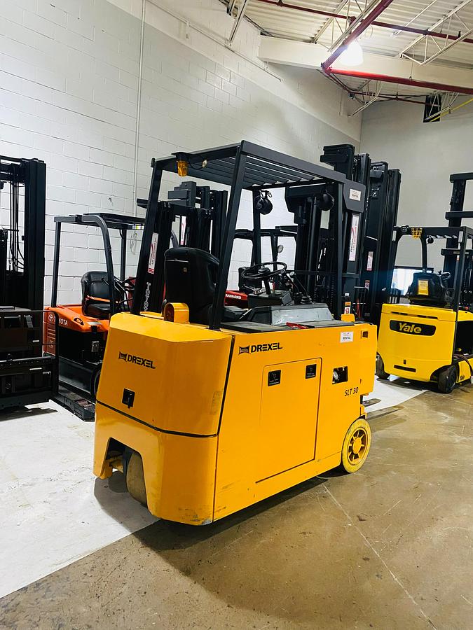 Back angled side view of Drexel SLT30 electric swing mast forklift showing counterweight, rear lights, and CSA-certified frame – unit staged in Brampton ON