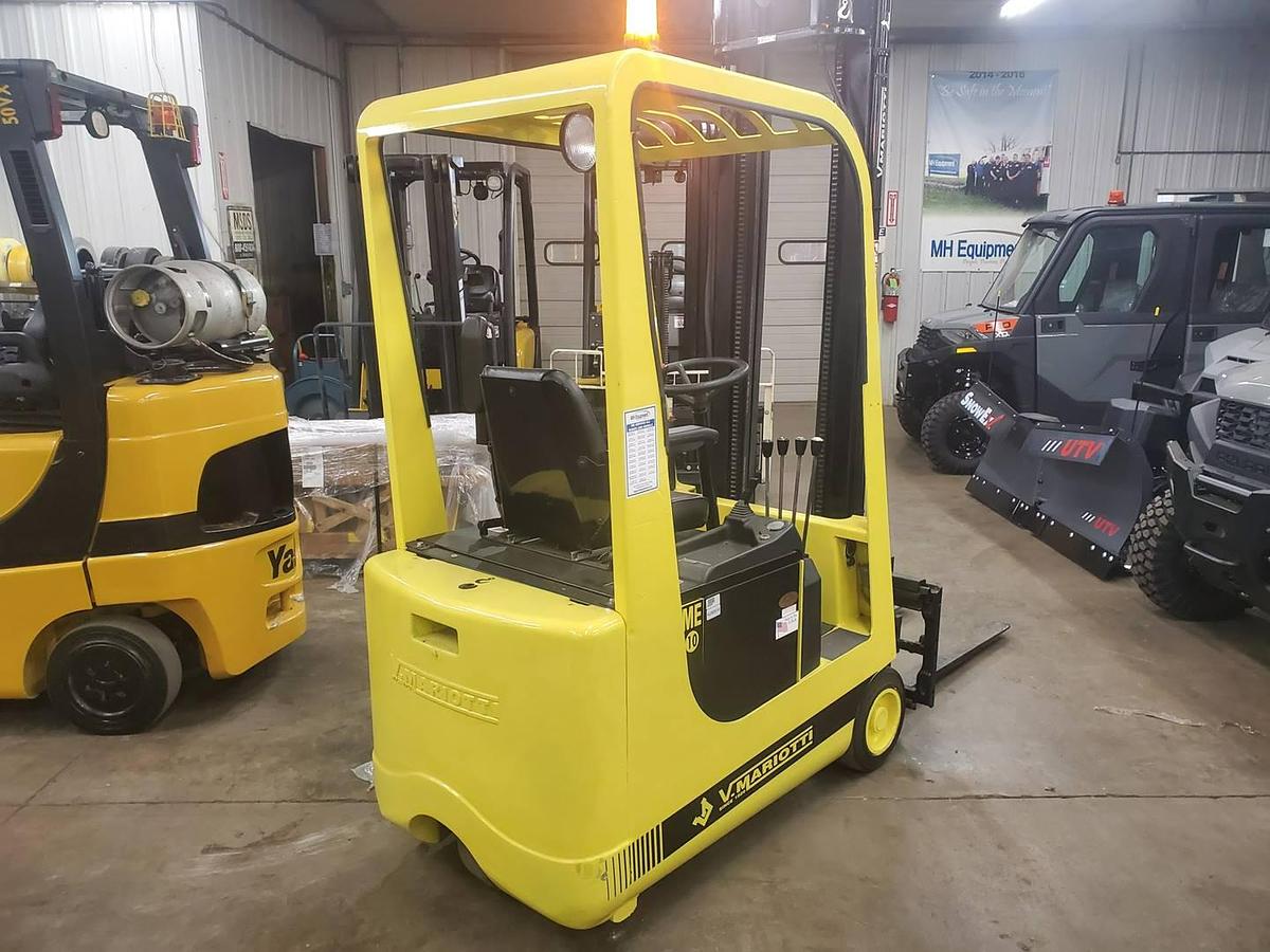 Rear opposite side view of refurbished 2008 Mariotti ME10 3‑wheel electric forklift showing operator compartment, rear chassis, battery compartment, and CSA certification decal during Brampton deployment.
