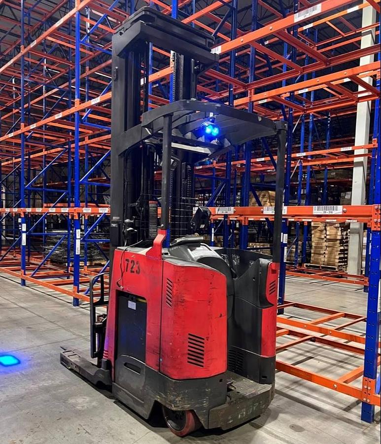 Rear side angle of Raymond 740DR32TT deep-reach forklift showing counterweight, rear wheels, and CSA certification during warehouse deployment
