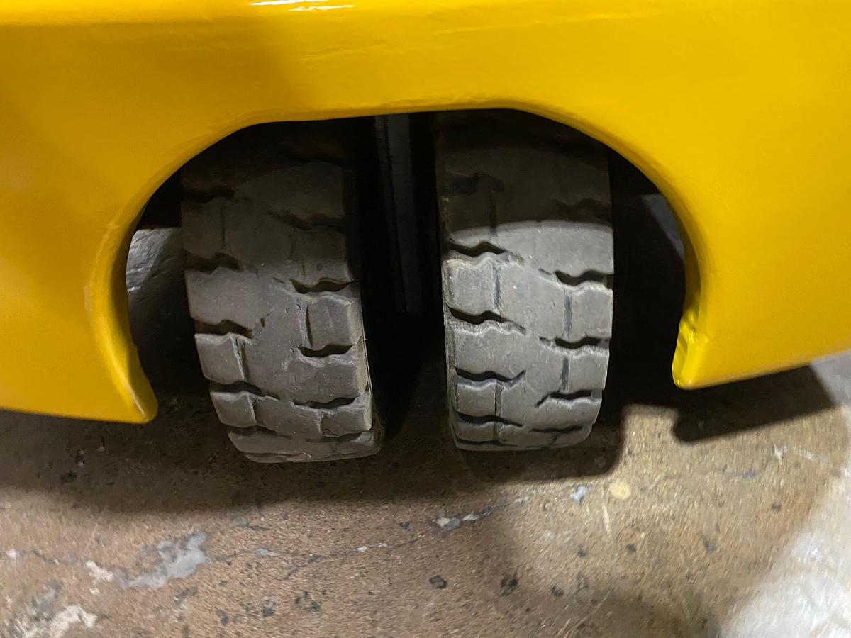 Rear solid pneumatic tire showing caster assembly and CSA spec