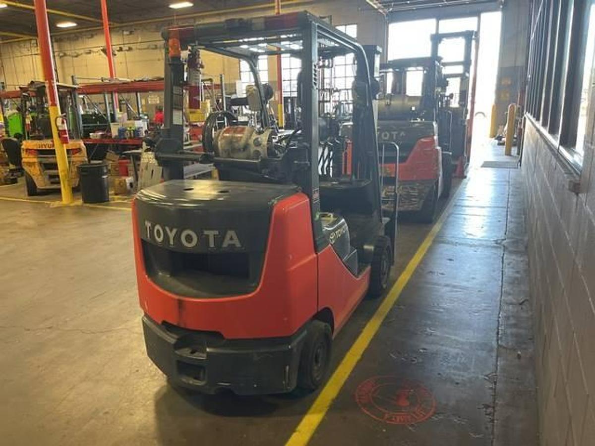 Rear view of refurbished 2018 Toyota 8FGCU30 LP gas forklift showing counterweight, propane tank mount, and CSA inspection tag during Brampton deployment
