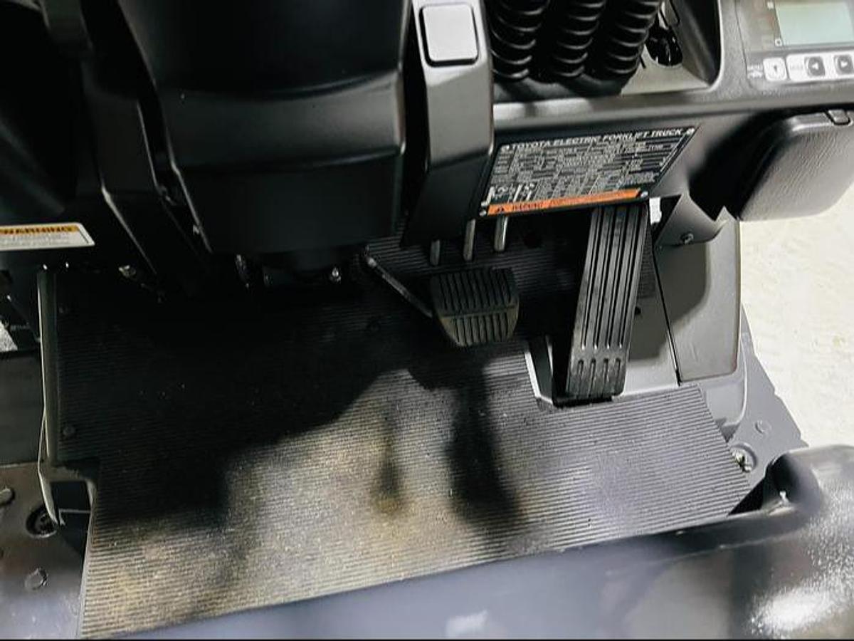 Operator footwell of refurbished 2023 Toyota 8FBE20U electric forklift showing accelerator pedal, brake pedal, and anti-slip mat during Mississauga deployment