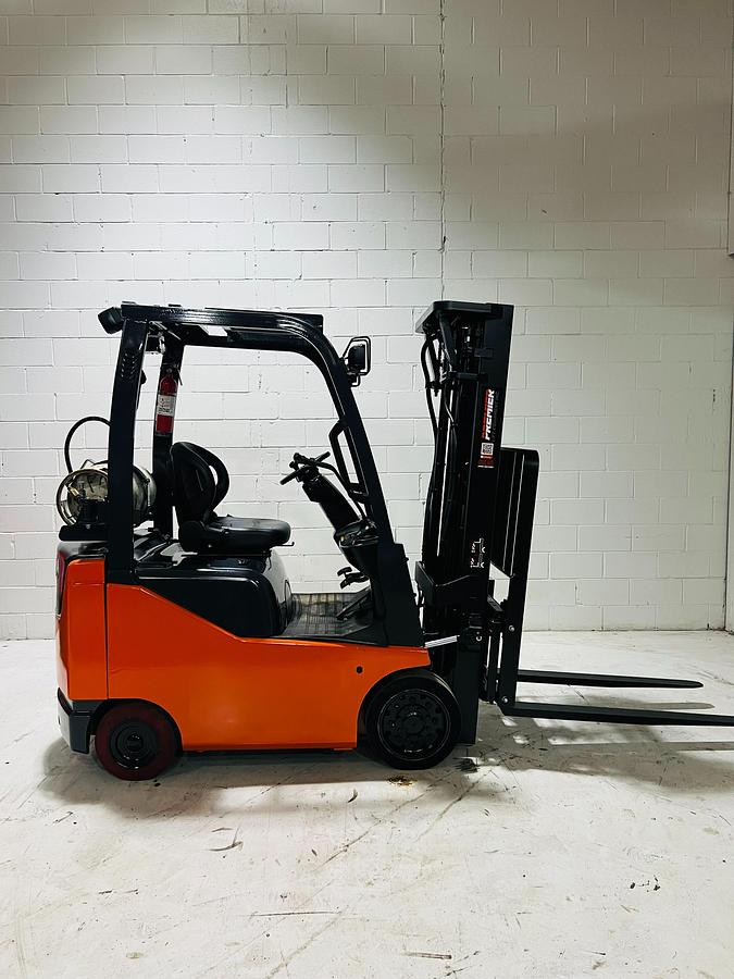 Opposite side view of 2020 Toyota 8FGCU18 propane forklift – CSA-certified 3,500 lb chassis with triple mast, side shift, and traction cushion tires shown reconditioned with propane tank mount and safety decals applied, Brampton ON – Premier Lift Equipment