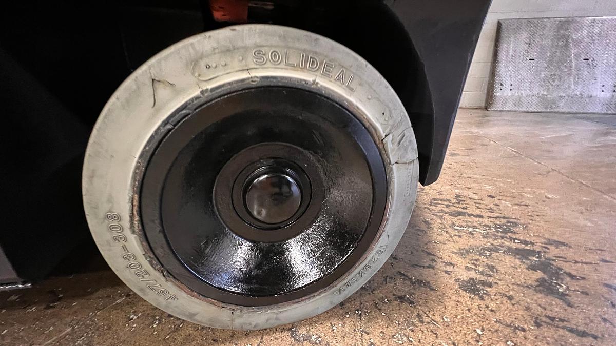 Left cushion steer tire showing wheel hub and CSA spec