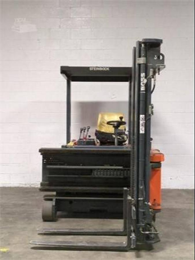 Front view of refurbished 1999 Steinbock VM13 swing mast man‑down turret truck showing 2" forks, swing mast turret, 203" lift height, and CSA certification decal during Brampton deployment.