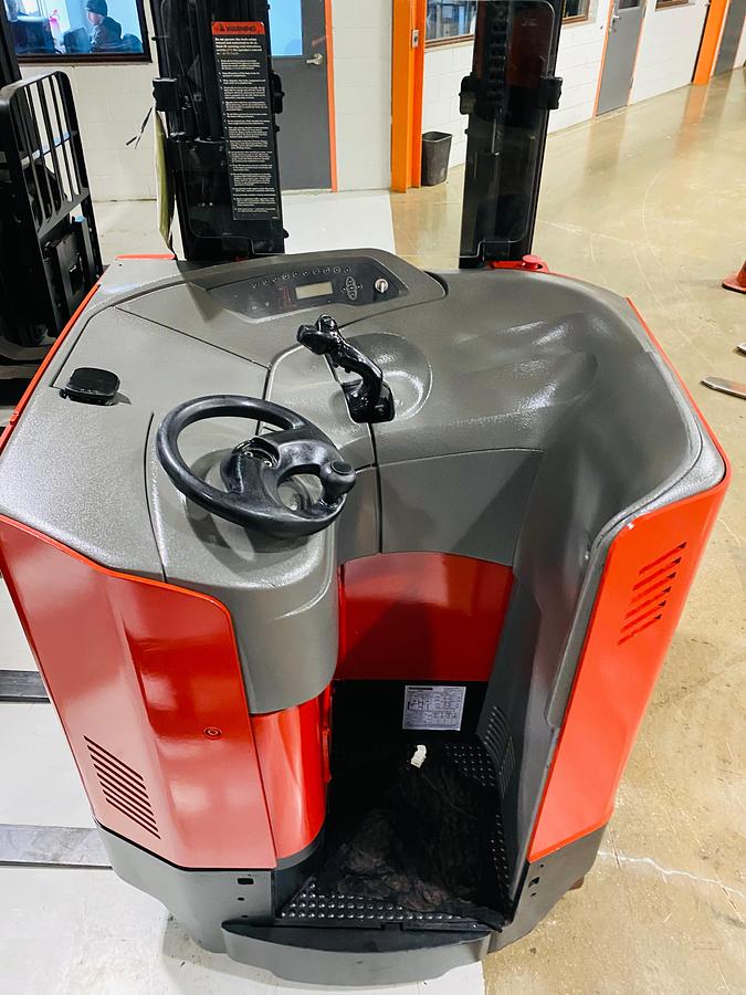 Operator compartment view showing stand-up controls and side-stance layout