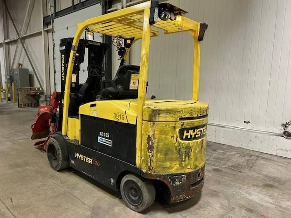 Rear side view of refurbished 2019 Hyster E120XN electric forklift showing rear chassis, non‑marking tires, and CSA certification decal during Ontario deployment.