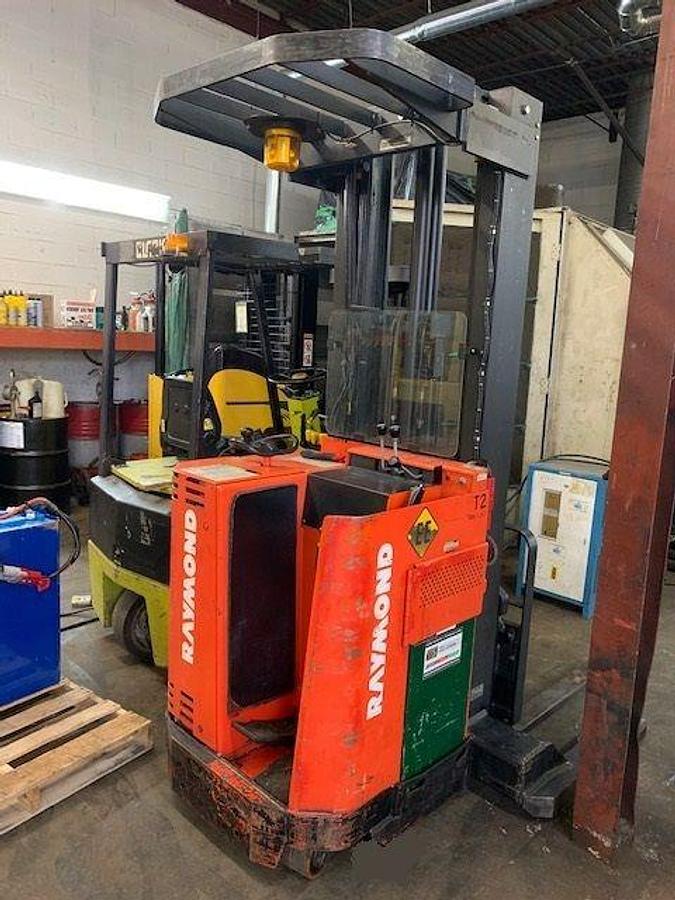 Rear angle side view of vintage 1992 Raymond 20IR40TT electric order picker showing counterweight, rear chassis panel, and platform base during Concord deployment