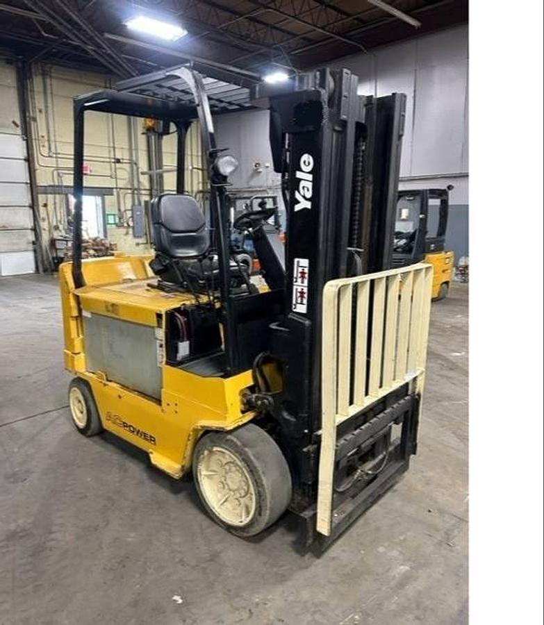 Side view of refurbished 2011 Yale ERC080HHN electric forklift showing operator cab, chassis, and triple mast during Brampton deployment