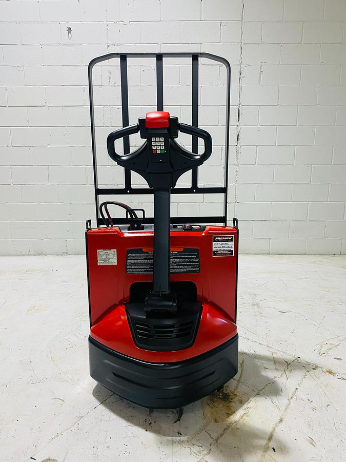 Back view of 2018 Raymond 8210 electric walkie pallet jack shown chassis only without battery or charger – CSA-certified 4,500 lb unit featuring rear counterweight, emergency reverse button, and non-marking polyurethane tires staged in Brampton ON; battery and charger available separately as extra options new or used – Premier Lift Equipment