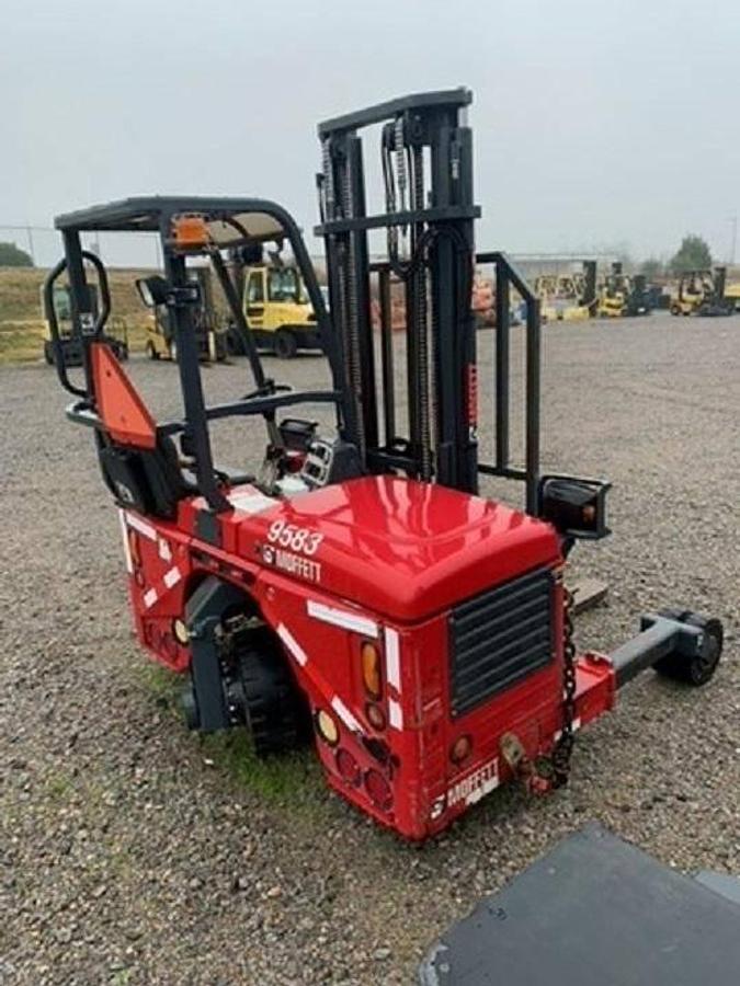 Rear side view of refurbished 2016 Moffett M4 36.1 T4 truck‑mounted sod lifter forklift showing rear chassis, pneumatic tires, diesel engine compartment, and CSA certification decal during Mississauga deployment.