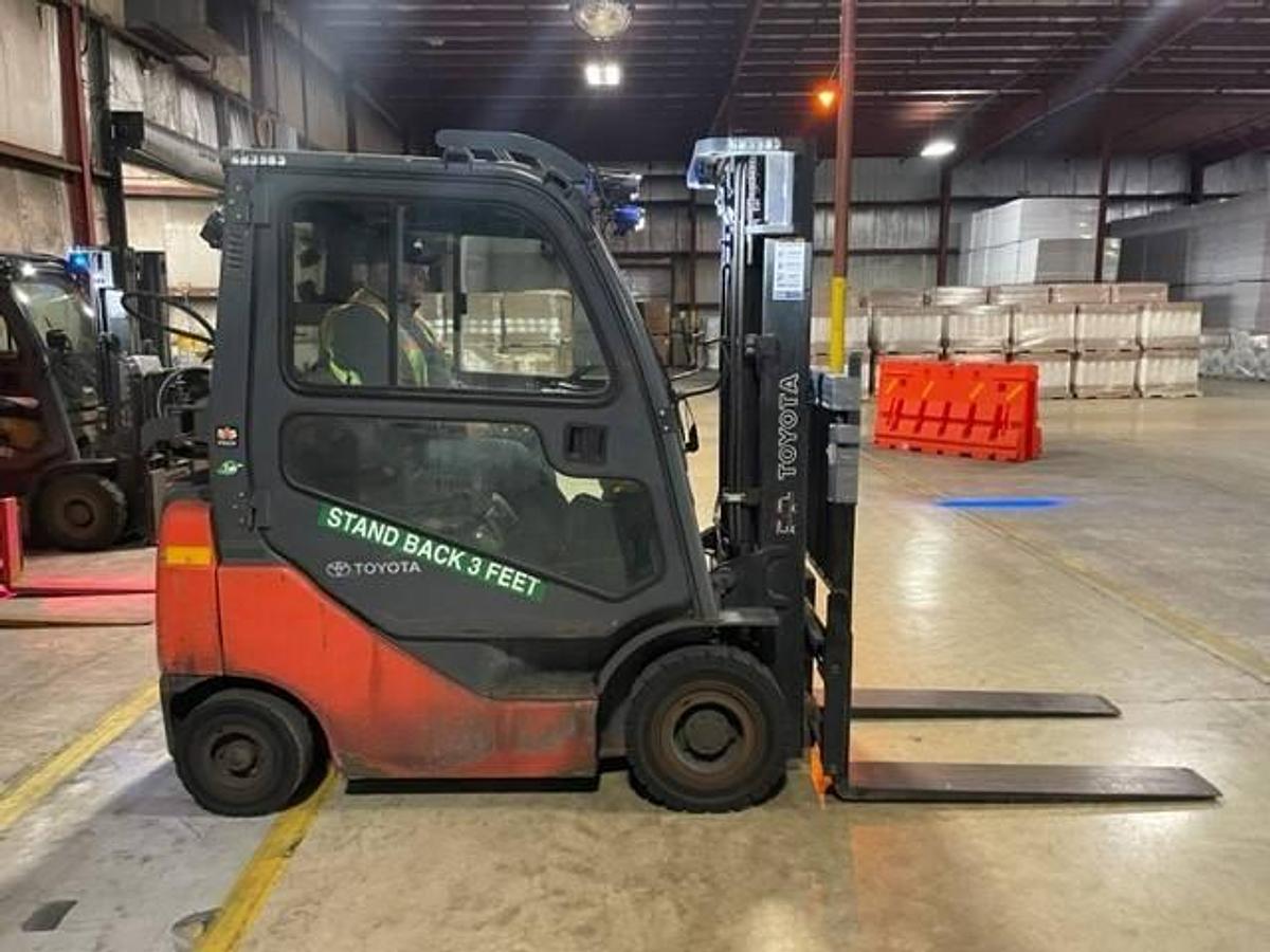 Opposite side view of refurbished 2016 Toyota 8FGU15 LP gas forklift showing rear chassis, propane tank mount, and CSA decal during Brampton deployment