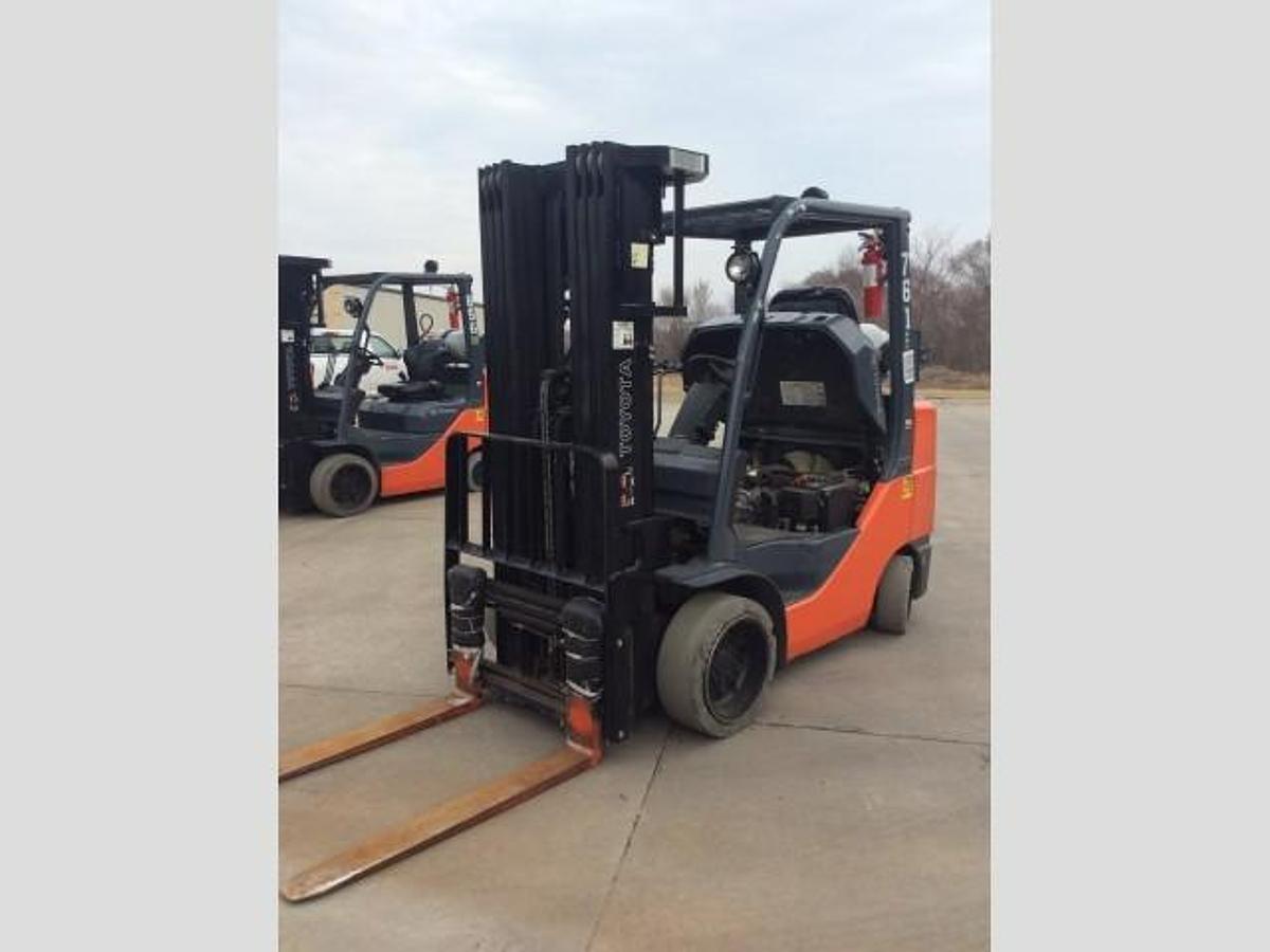 Front side view of refurbished 2014 Toyota 8FGCU30 LP gas forklift showing triple mast, 42" forks, and solid cushion tires during Brampton deployment