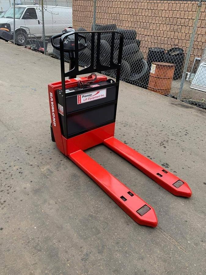 Front view of refurbished 2014 Raymond 102T-F45L electric walkie pallet truck showing 27" x 45" forks, fork heels, and front chassis panel during Oakville deployment