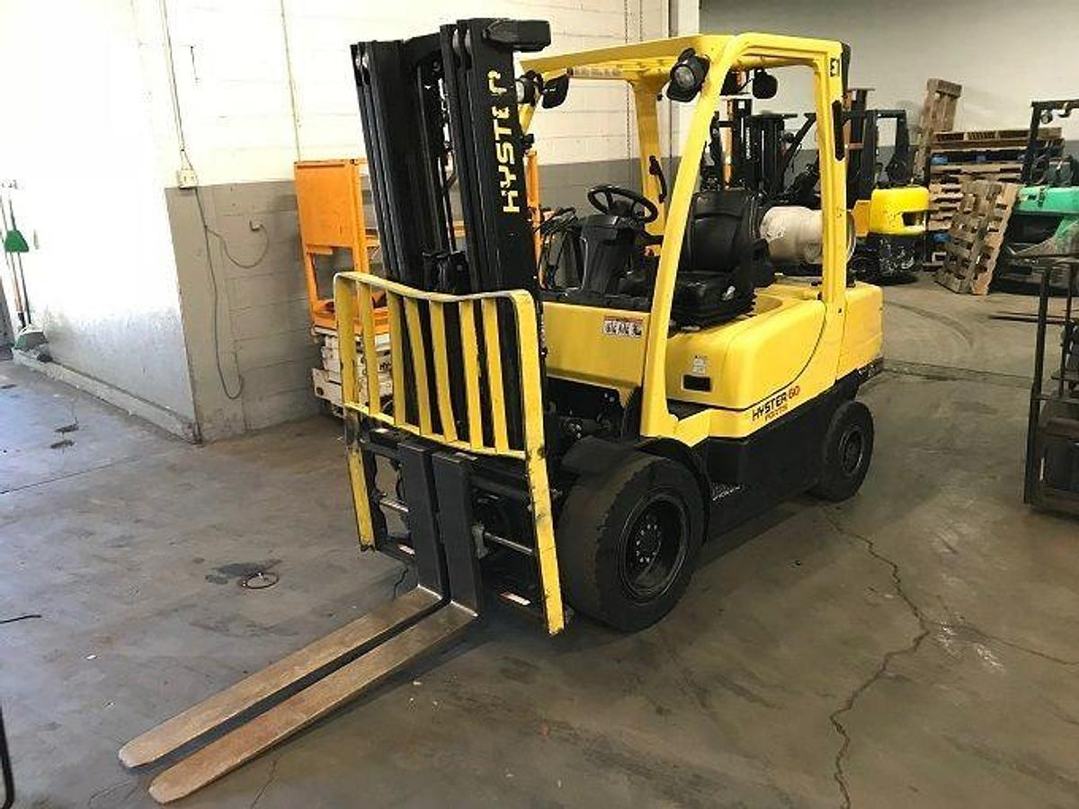 Front view of refurbished 2011 Hyster H60FT LP Gas forklift showing forks with side‑shifting fork positioner, solid pneumatic tires, and CSA certification decal during Ontario deployment.