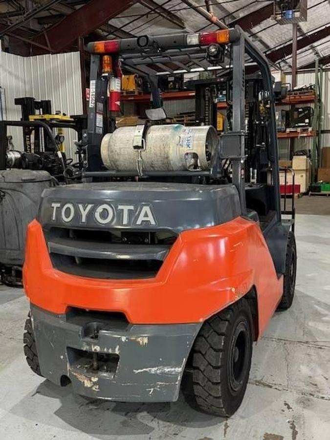 Back view of refurbished Toyota LP gas forklift showing counterweight, propane tank mount, and CSA inspection tag during Brampton deployment