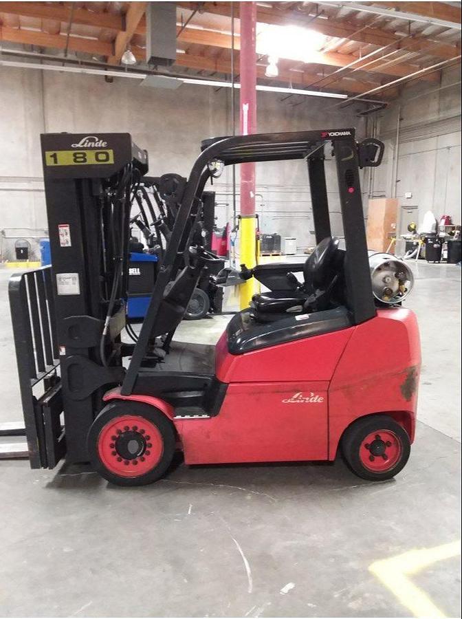 Side view of refurbished 2016 Linde H25CT LPG forklift showing 60" forks, solid tires, load back rest, quad mast with side shift, and CSA certification decal during Brampton deployment.