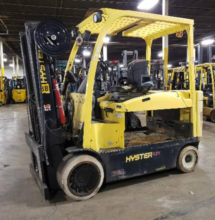 Side view of refurbished 2016 Hyster E120XN electric forklift showing 2‑stage mast with 111" lift height, solid tires, 36/48V battery compartment, and CSA certification decal during Ontario deployment.