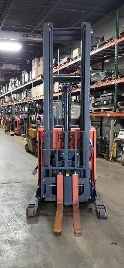 Front view of Toyota 9BRU23 single reach electric forklift shown chassis only with optional new or used battery available – CSA-certified 4,500 lb unit featuring 280” triple mast, 42” forks with side shift, compact stand-up operator station, and 36V AC chassis staged in Brampton ON – Premier Lift Equipment