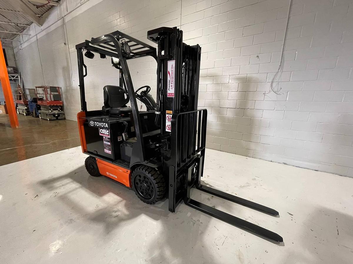 Refurbished 2017 Toyota 8FBCU25 electric forklift with 189" triple mast and CSA decals shown at front side angle during Brampton deployment