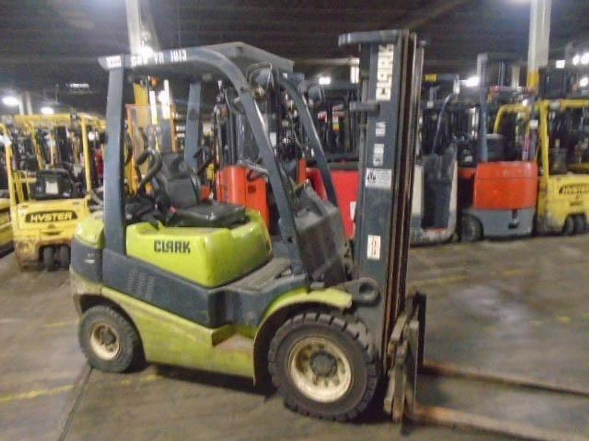 Side view of refurbished 2006 Clark C25L LPG forklift showing solid pneumatic tires, 42" forks, 3‑stage mast with side shift, and CSA certification decal during Brampton deployment.