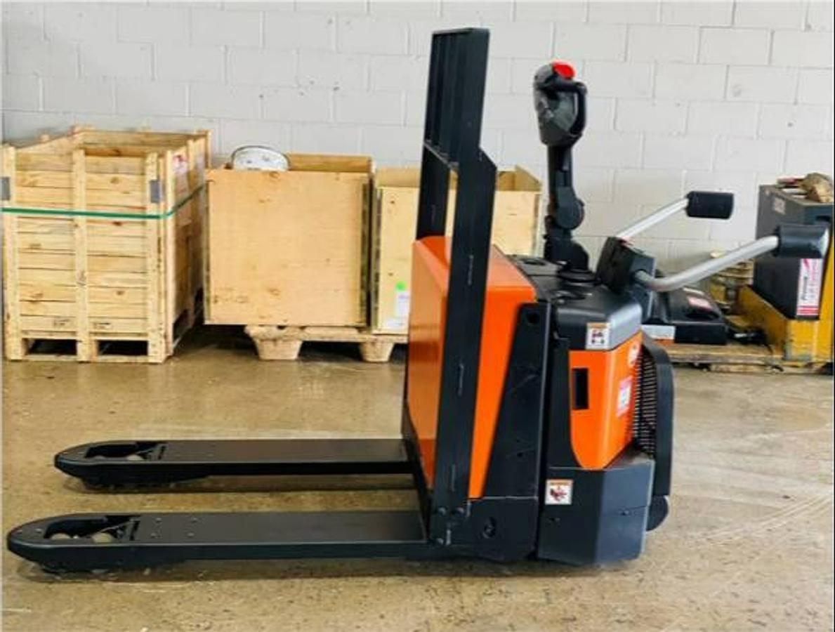 Side view of refurbished 2016 BT LPE200/8 electric walkie/rider pallet jack showing 27" x 45" forks, flip‑down operator platform, load backrest, and CSA certification decal during Ontario deployment.