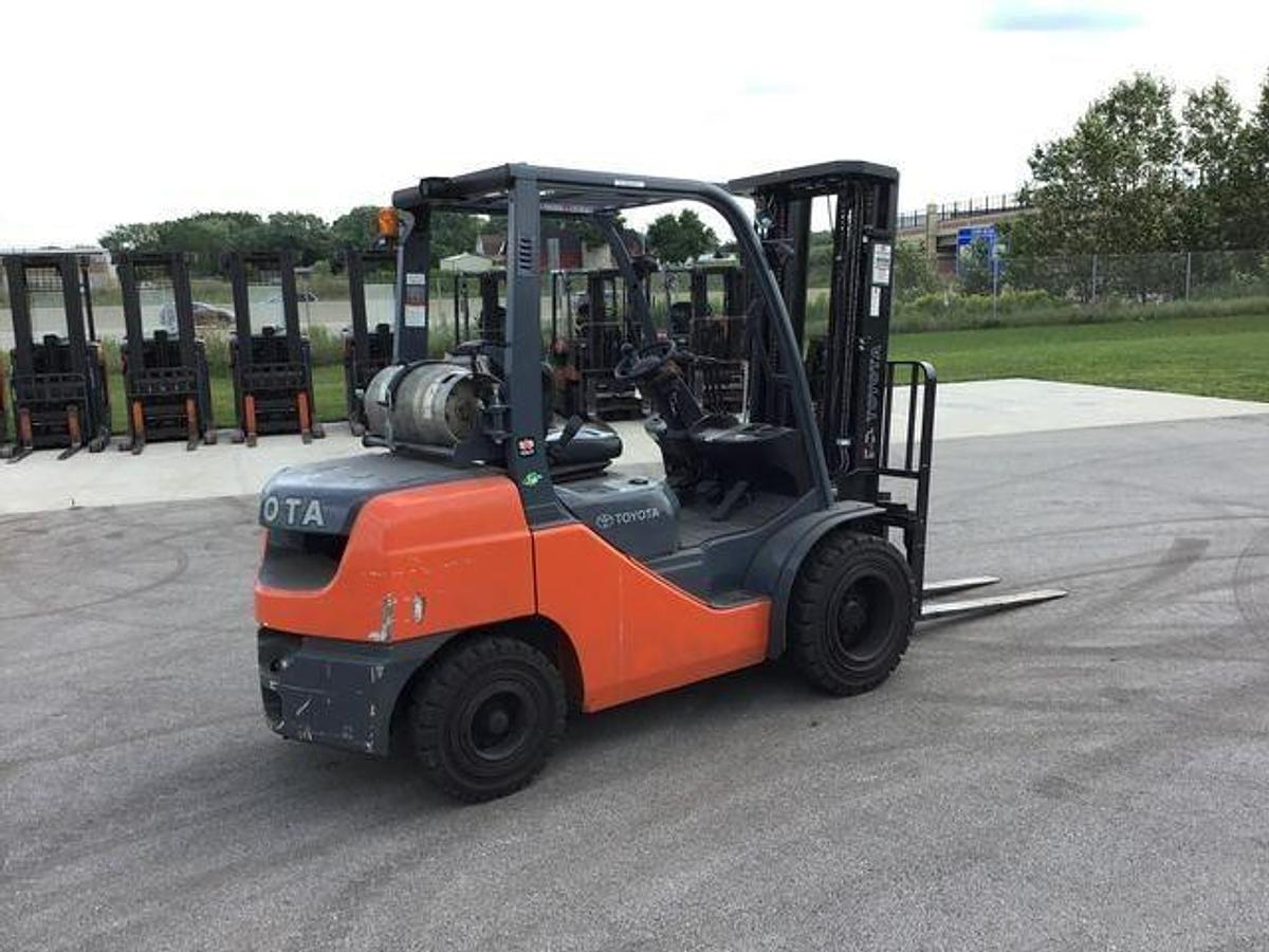 Opposite side view of refurbished 2016 Toyota 8FGU30 LP gas forklift showing rear chassis, propane tank mount, and CSA decal during Brampton deployment