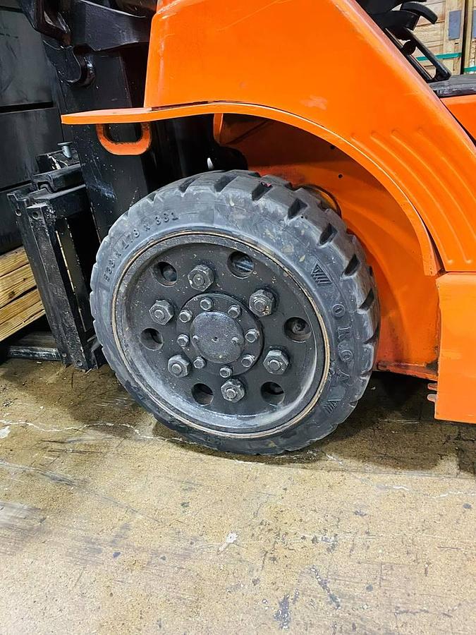 Opposite traction drive tire on refurbished Toyota LP gas forklift showing matching tread and solid cushion profile during Brampton deployment