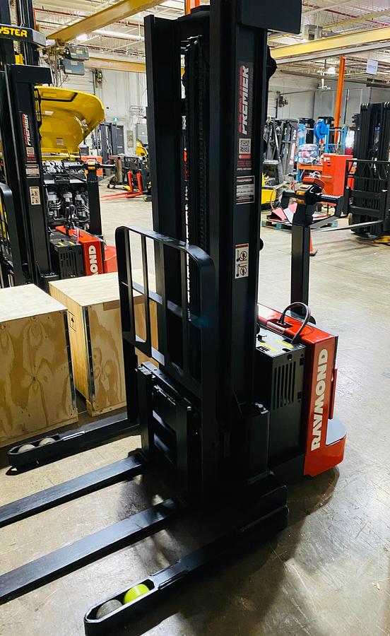 "Side view of refurbished Raymond RSS walkie straddle stacker with 42-inch forks"