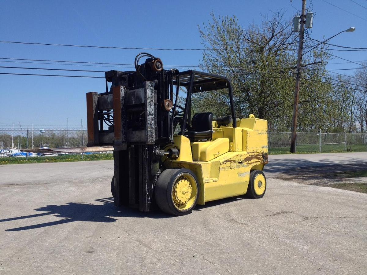High‑capacity cushion tire forklift (15,000 lb+), LPG or diesel powered, solid non‑marking cushion tires, indoor warehouse use, heavy‑duty mast, enclosed cab, overhead guard.