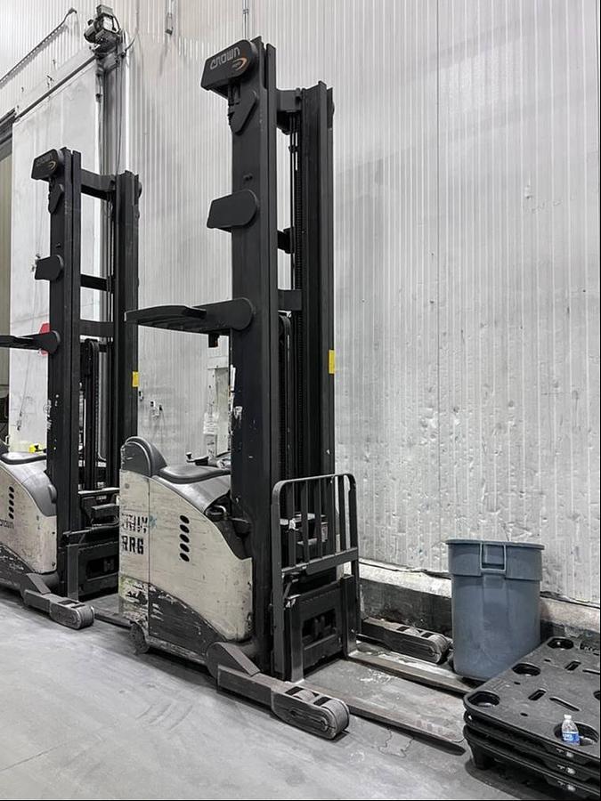 Front angled view of refurbished 2012 Crown RR5700 electric reach truck showing 42" forks, 42" B.L.O., 400" mast, 21.5" battery box, and CSA certification decal during Ontario deployment.
