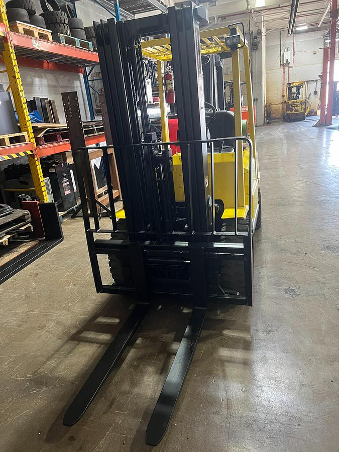 Front view of Hyster H50XM propane pneumatic forklift – CSA-certified 5,000 lb chassis with 189” triple mast, integral side shift, 42” forks, and clamp-ready hydraulics shown refurbished and sold chassis-only – safety-tagged in Brampton ON – Premier Lift Equipment