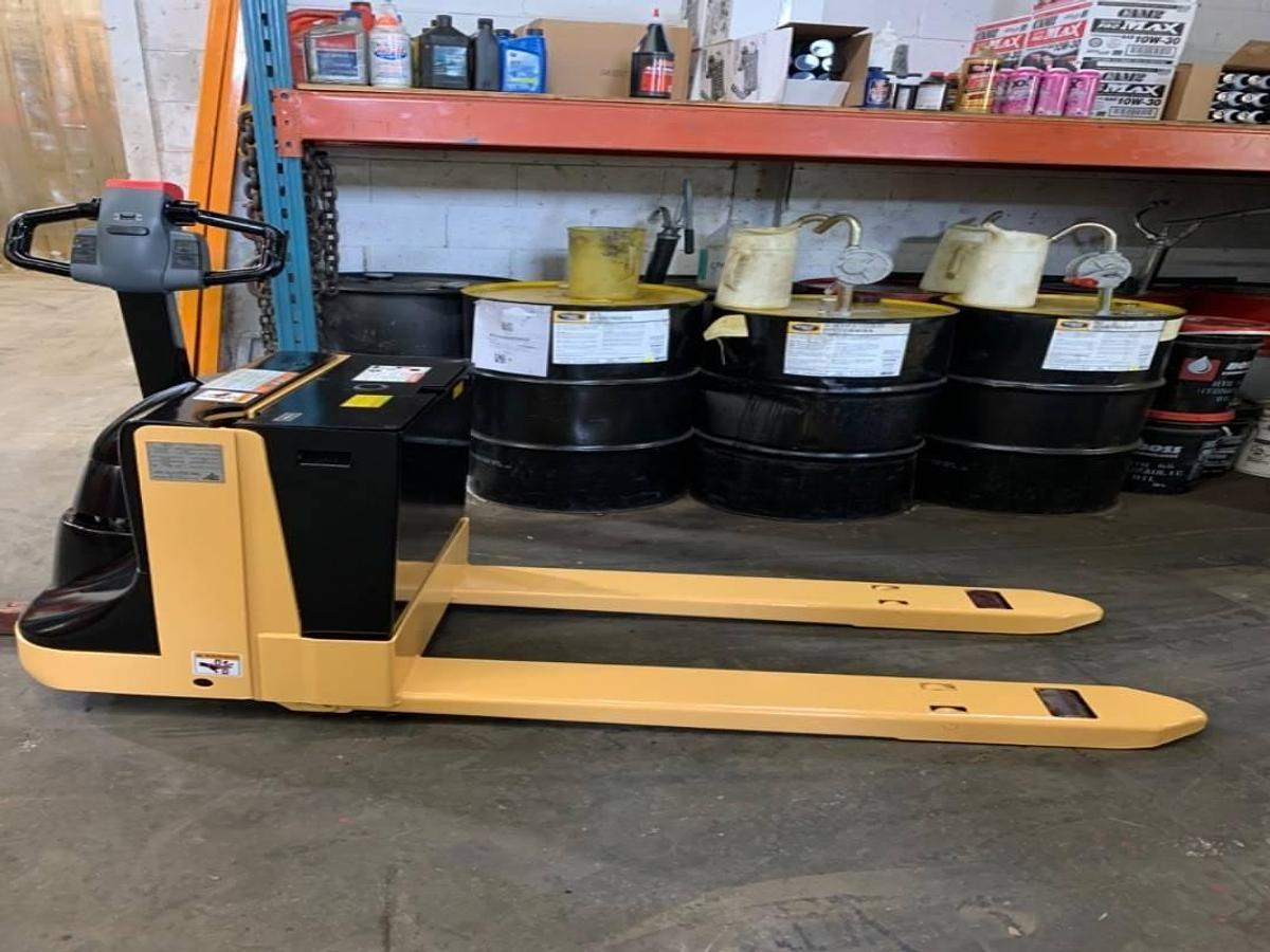 Side view of refurbished 2014 Big Joe WPT45 electric walkie pallet jack showing 27" x 45" forks, power drive chassis, battery compartment, and CSA certification decal during Ontario deployment.