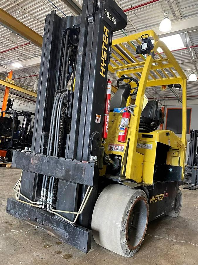Front view of refurbished 2019 Hyster E120XN electric forklift showing forks, 83"/169" triple mast, solid tires, and CSA certification decal during Ontario deployment.