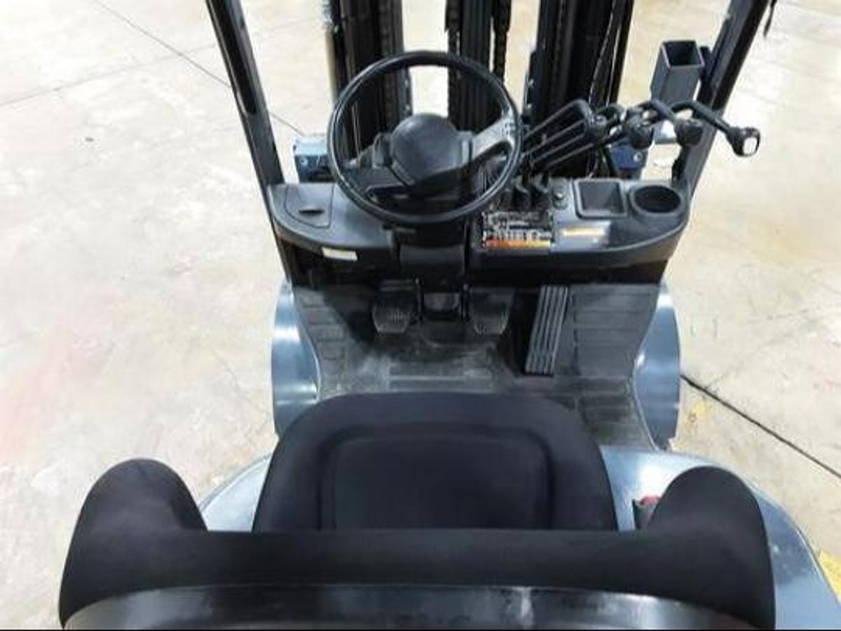 Operator’s compartment of refurbished Toyota LP gas forklift showing replacement seat, steering wheel, and hydraulic levers during Brampton deployment