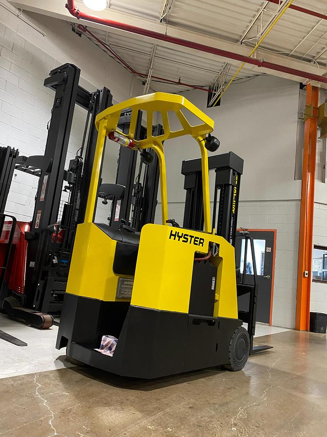 Rear-right angle view of Hyster E30FR-24 electric dockstocker showing stand-up rider platform, rear-wheel drive configuration, and CSA-certified chassis – unit staged in GTA ON