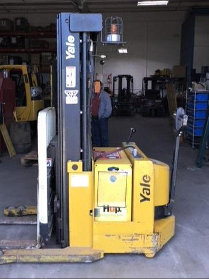 Side view of refurbished 1997 Yale MRW030 electric walkie straddle stacker reach showing triple stage mast, CSA decal, and 189" lift height during Ontario deployment.