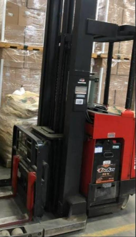 Side view of refurbished 2000 Raymond EZACT45TT electric reach truck showing battery compartment, chassis frame, and 33" base legs during Vaughan deployment
