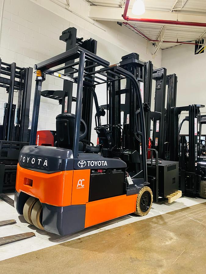 Opposite rear side angle view of 2022 Toyota 8FBE20U electric forklift showing quad mast, rear chassis, and 3-wheel configuration with non-marking tires during Brampton deployment