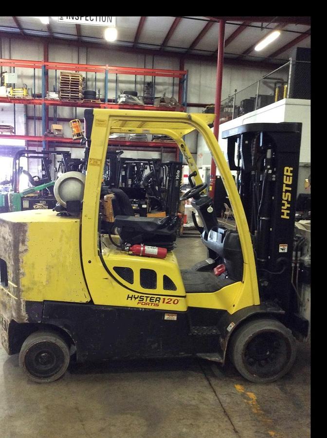 Side profile of 2010 Hyster S120FT LPG cushion forklift showing mast rails, chassis layout, and indoor tires during Brampton deployment