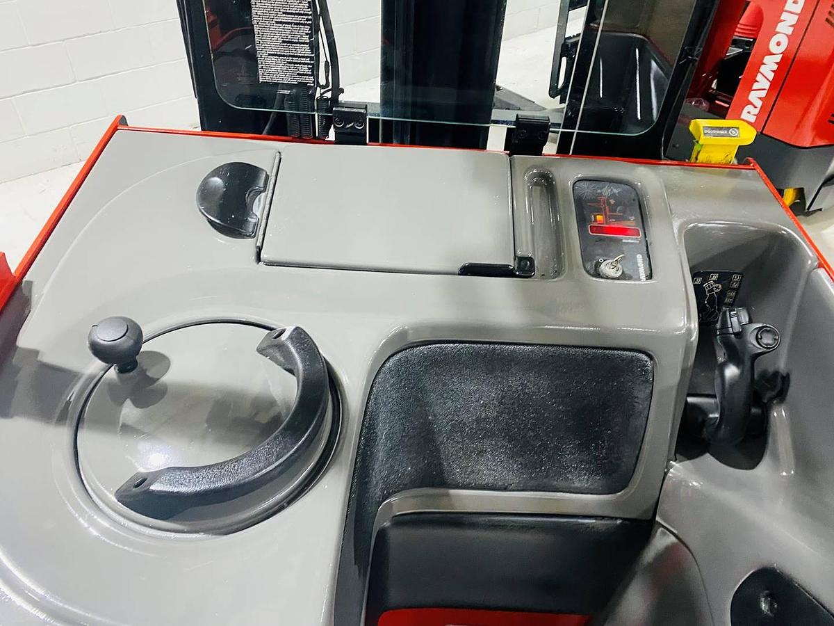 Alt="Front dash view of SOLD 2000 Raymond EASIR40TT reach truck highlighting controls, steering column, and CSA/MOL certification decals"