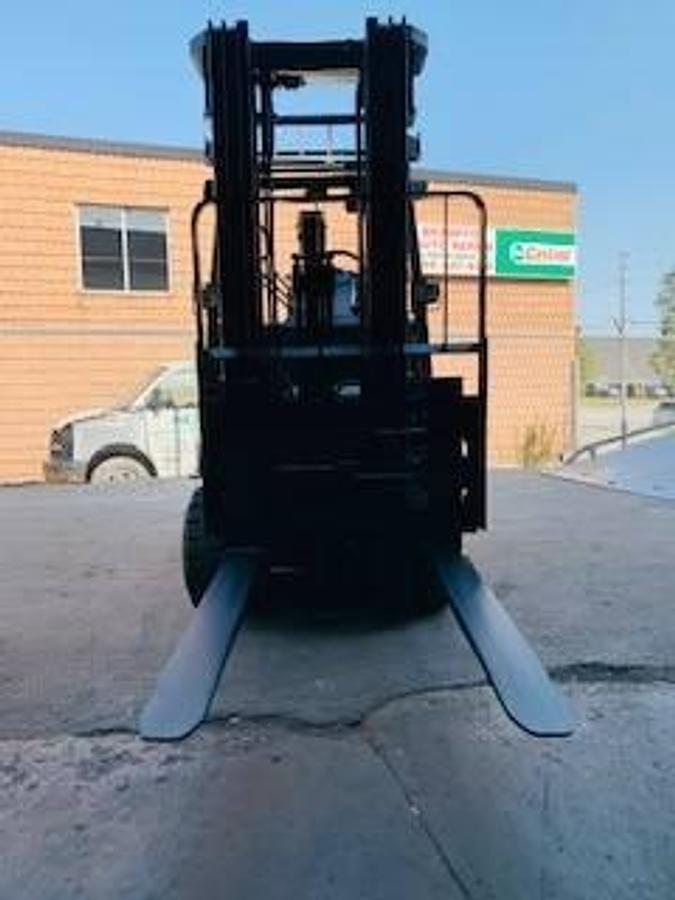 Head-on view of 2020 Toyota 8FBCU30 electric forklift with forks lowered, triple mast extended, and CSA safety markings visible