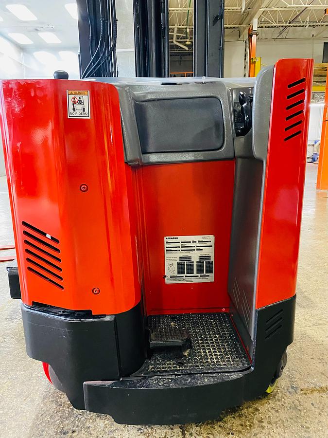 Close-up view of Raymond EASI 4D-R45TT electric reach truck showing chassis frame, operator compartment, steering wheel, and CSA safety decals during Brampton deployment