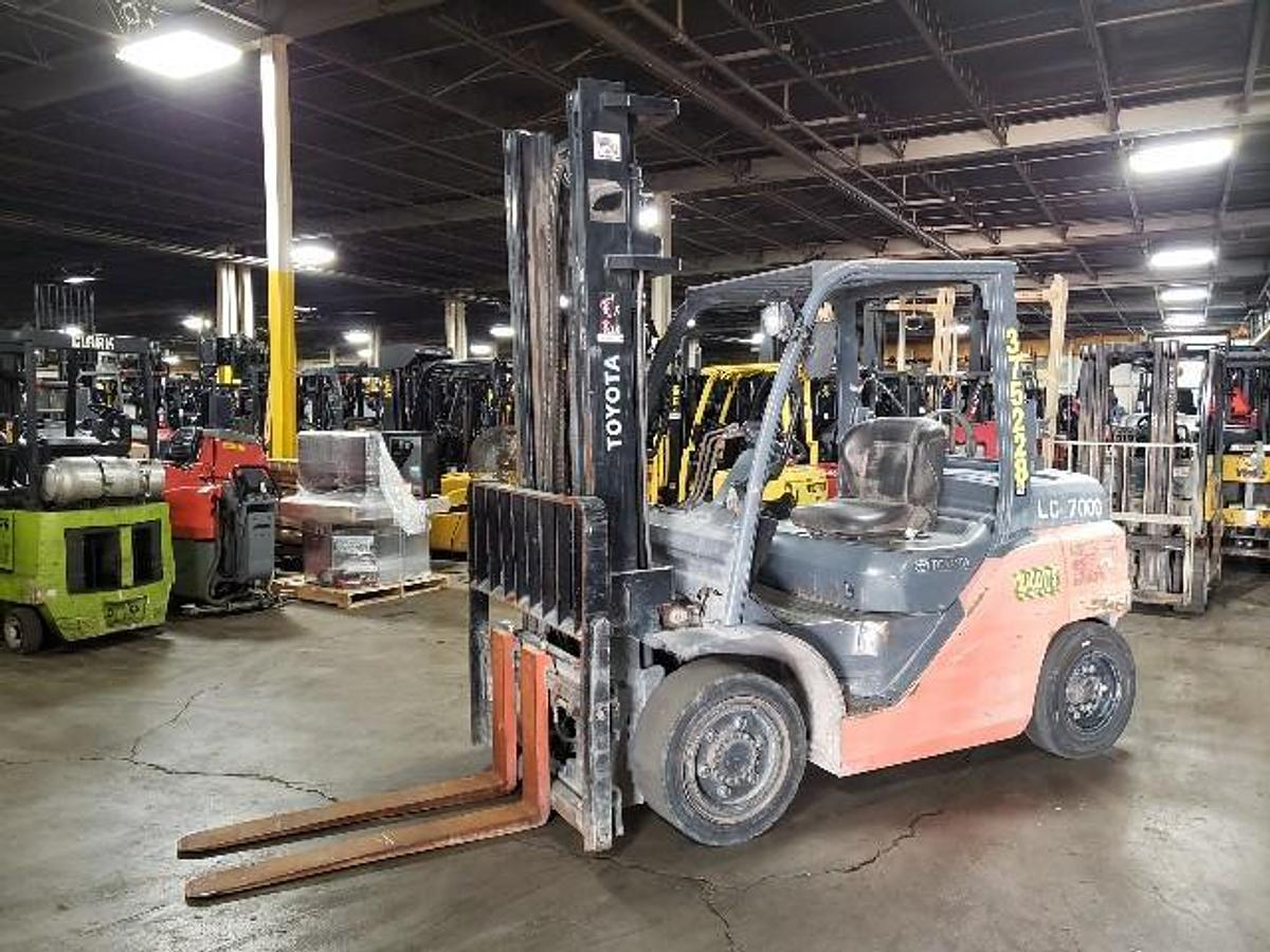 Side view of 2015 Toyota 8FG35U forklift with 8,000 lb capacity and solid pneumatic tires