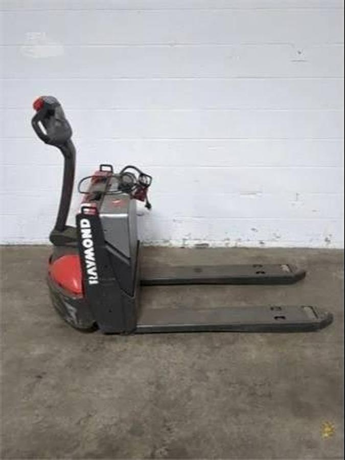 Side view of refurbished 2018 Raymond 8250 electric walkie pallet truck showing battery compartment, tiller arm, and chassis frame during Oakville deployment