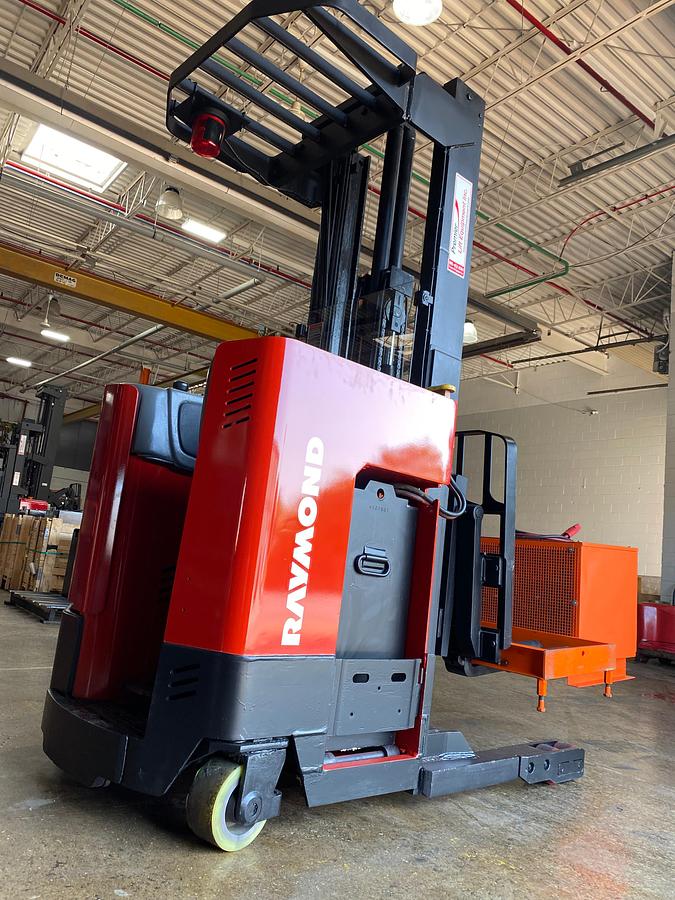 Rear view showing counterweight and mounted safety lighting and charger on forks