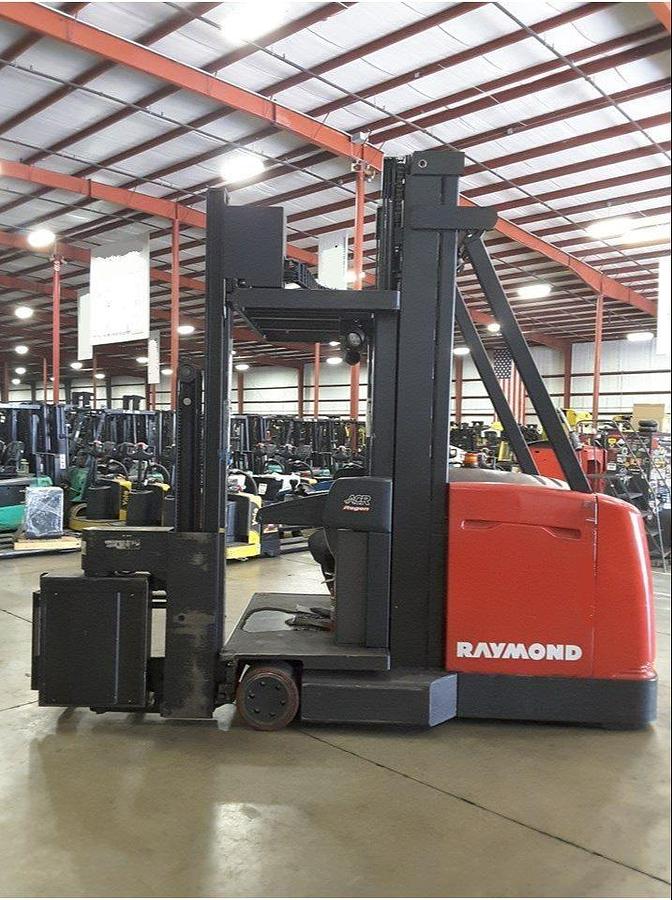 Side view of refurbished 2012 Raymond 960-CSR30TT electric man-up turret truck showing swing reach mast, CSA decal, and 61" wide chassis during Ontario deployment