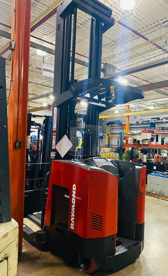 Rear angle view of Budget Raymond reach truck — counterweight, chassis, and mast base.