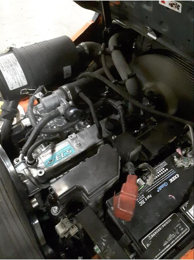 Engine compartment of refurbished Toyota LP gas forklift showing LP gas powertrain, cooling system, and service access during Brampton deployment
